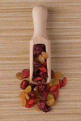 Image showing Wooden scoop with mixed dried fruits