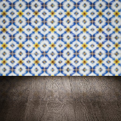 Image showing Wood table top and blur vintage ceramic tile pattern wall