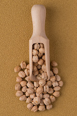 Image showing Wooden scoop with chickpeas