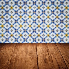 Image showing Wood table top and blur vintage ceramic tile pattern wall