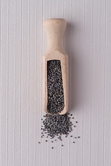 Image showing Wooden scoop with poppy seeds