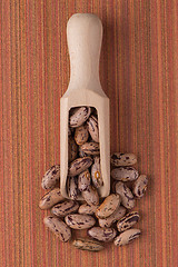 Image showing Wooden scoop with pinto beans