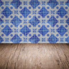 Image showing Wood table top and blur vintage ceramic tile pattern wall