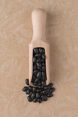 Image showing Wooden scoop with black beans