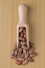 Image showing Wooden scoop with pinto beans