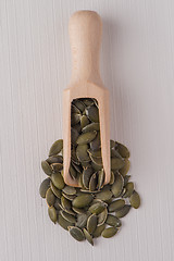 Image showing Wooden scoop with pumpkin seeds