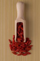 Image showing Wooden scoop with dry red goji berries