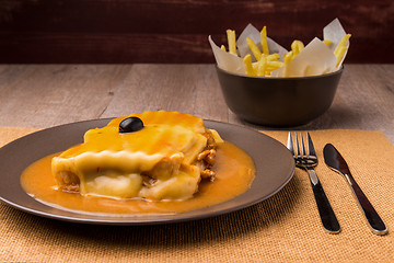 Image showing Francesinha and french fries