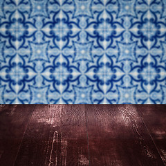 Image showing Wood table top and blur vintage ceramic tile pattern wall