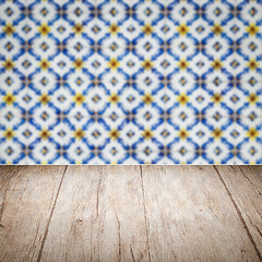 Image showing Wood table top and blur vintage ceramic tile pattern wall