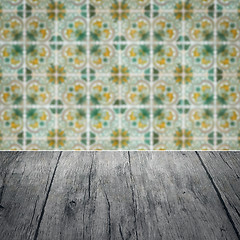 Image showing Wood table top and blur vintage ceramic tile pattern wall