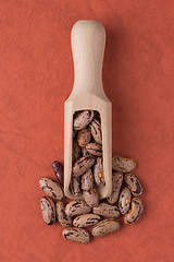 Image showing Wooden scoop with pinto beans