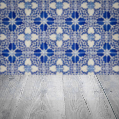 Image showing Wood table top and blur vintage ceramic tile pattern wall