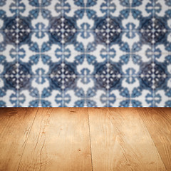 Image showing Wood table top and blur vintage ceramic tile pattern wall