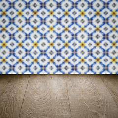 Image showing Wood table top and blur vintage ceramic tile pattern wall