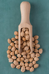 Image showing Wooden scoop with chickpeas