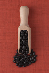 Image showing Wooden scoop with black beans