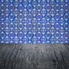 Image showing Wood table top and blur vintage ceramic tile pattern wall