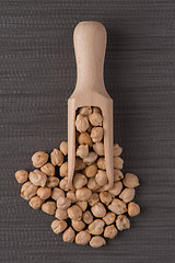 Image showing Wooden scoop with chickpeas