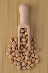 Image showing Wooden scoop with chickpeas