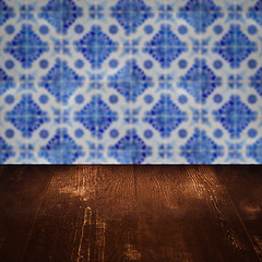 Image showing Wood table top and blur vintage ceramic tile pattern wall