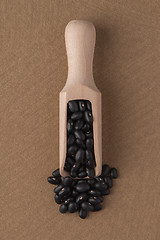 Image showing Wooden scoop with black beans