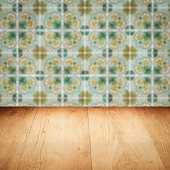 Image showing Wood table top and blur vintage ceramic tile pattern wall