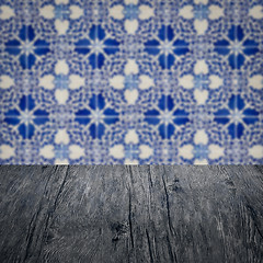 Image showing Wood table top and blur vintage ceramic tile pattern wall