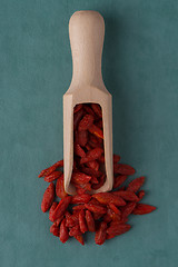 Image showing Wooden scoop with dry red goji berries