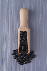 Image showing Wooden scoop with black beans