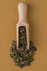 Image showing Wooden scoop with pumpkin seeds