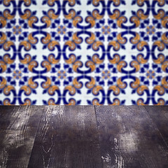 Image showing Wood table top and blur vintage ceramic tile pattern wall