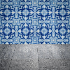 Image showing Wood table top and blur vintage ceramic tile pattern wall