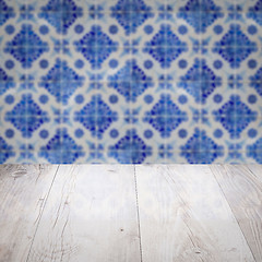 Image showing Wood table top and blur vintage ceramic tile pattern wall