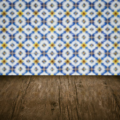 Image showing Wood table top and blur vintage ceramic tile pattern wall