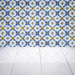 Image showing Wood table top and blur vintage ceramic tile pattern wall