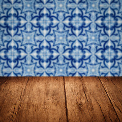 Image showing Wood table top and blur vintage ceramic tile pattern wall