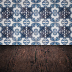 Image showing Wood table top and blur vintage ceramic tile pattern wall