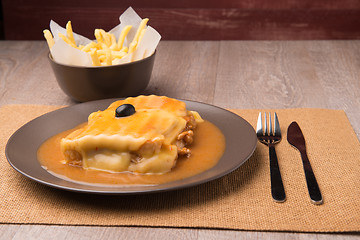 Image showing Francesinha and french fries