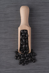 Image showing Wooden scoop with black beans