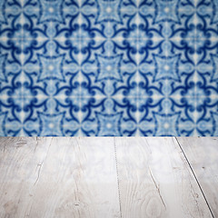 Image showing Wood table top and blur vintage ceramic tile pattern wall