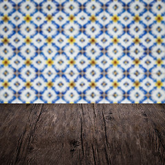 Image showing Wood table top and blur vintage ceramic tile pattern wall