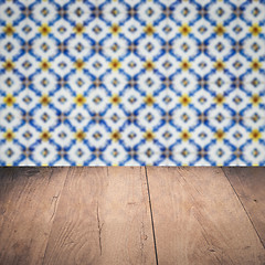 Image showing Wood table top and blur vintage ceramic tile pattern wall