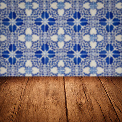 Image showing Wood table top and blur vintage ceramic tile pattern wall