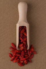 Image showing Wooden scoop with dry red goji berries