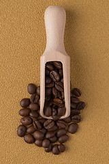 Image showing Wooden scoop with coffee beans