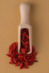 Image showing Wooden scoop with dry red goji berries