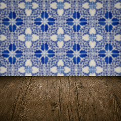 Image showing Wood table top and blur vintage ceramic tile pattern wall