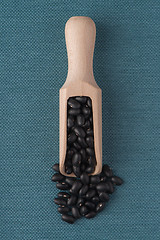 Image showing Wooden scoop with black beans