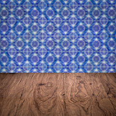 Image showing Wood table top and blur vintage ceramic tile pattern wall